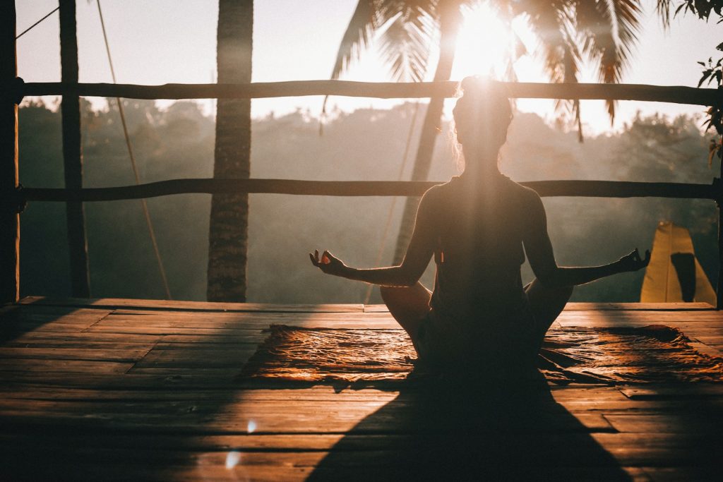 woman in black tank top sitting on brown wooden dock during daytime, blog post about best health and wellness affiliate programs in 2025