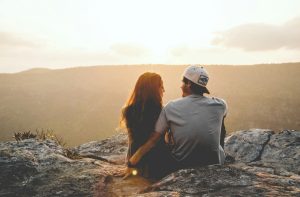man and woman sitting on rock during daytime, it's for a blog post about insecure attachment style
