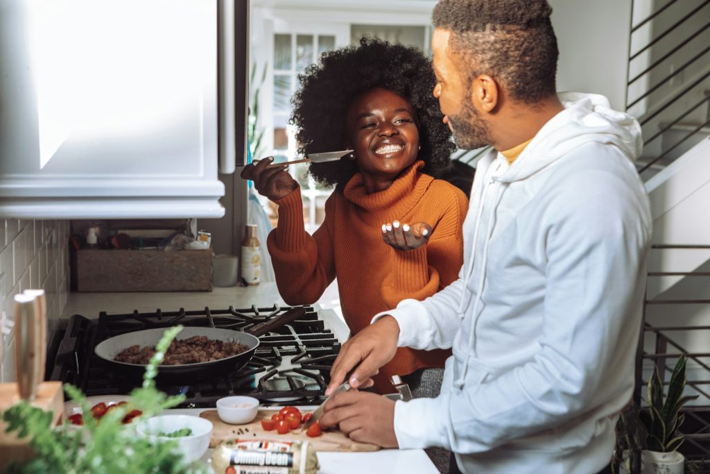 couple cooking together - Blair Nicole | Mental Health, Relationships, Travel man in white dress shirt holding a woman in brown long sleeve shirt
