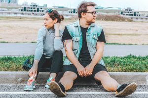couple - Blair Nicole | Mental Health, Relationships, Travel woman looking at her right sitting at curb beside man looking at his left couple navigating difficult time